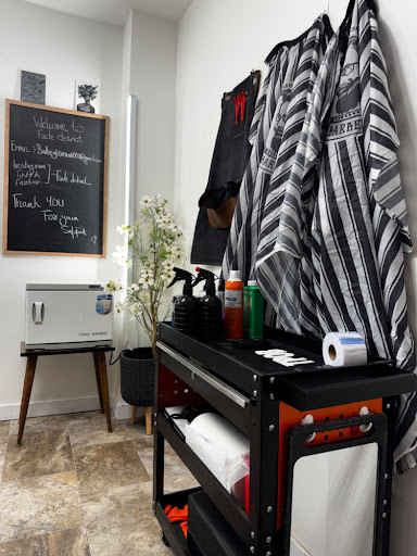 Barber capes and sanitised equipment cart in the studio