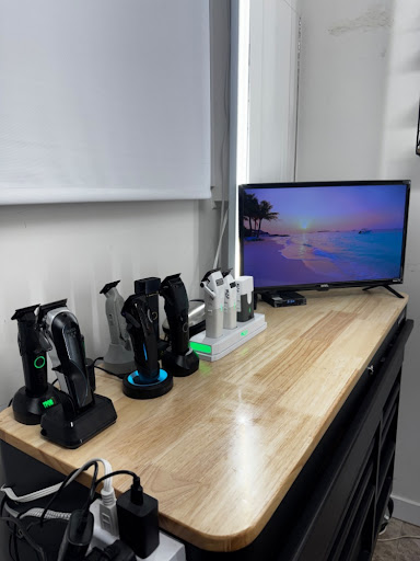 Clipper station and screen inside the Kingston barber studio